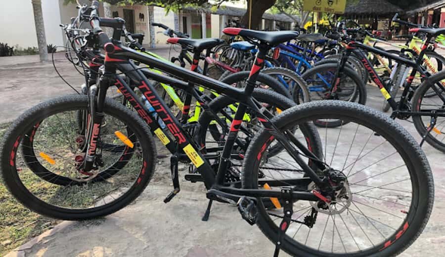 Diani Beach: Village tour on a bike with hotel pick-up - From hotel lobby to Diani Bazaar: how the 4-hour bike loop flows